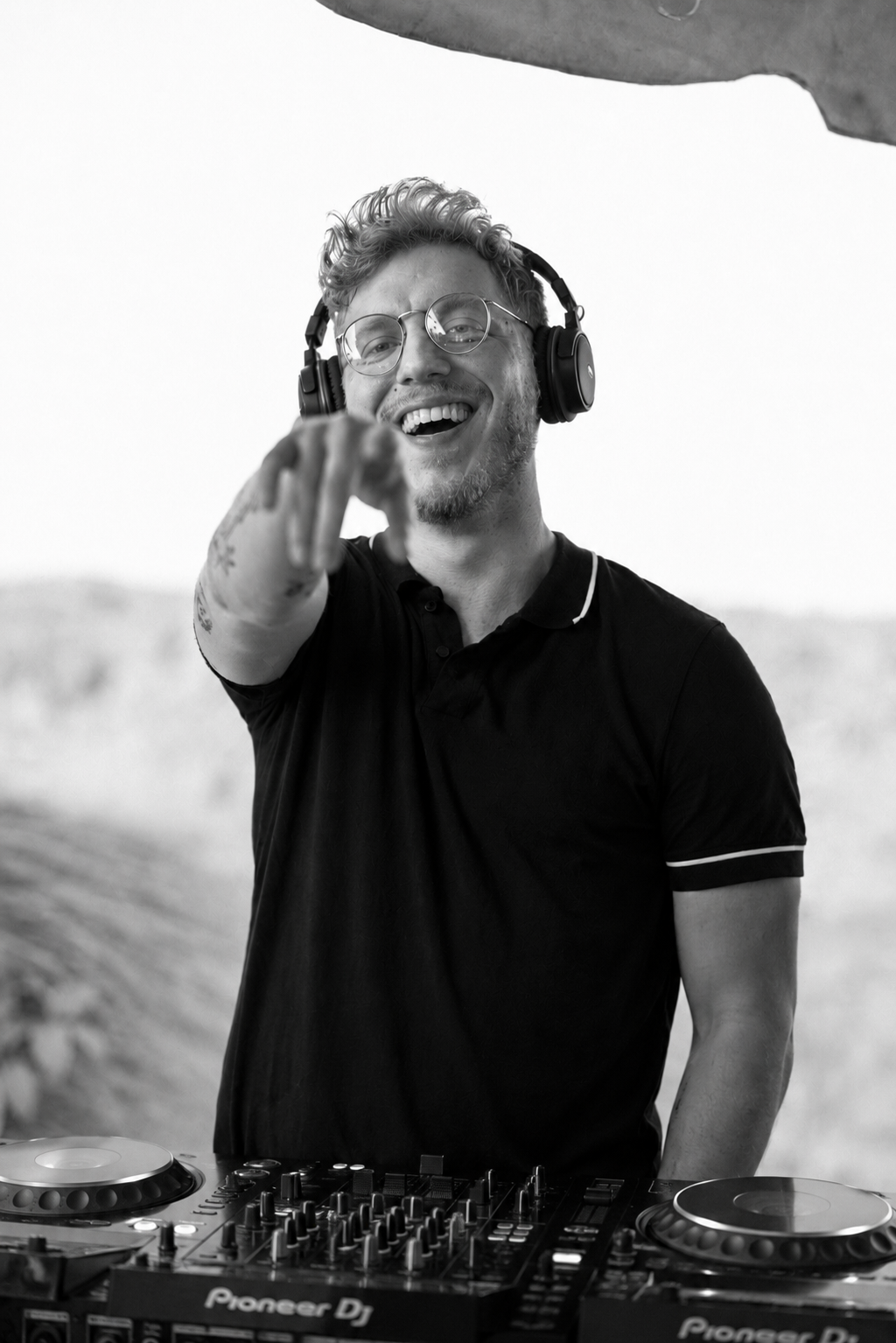 Matt smiling behind the DJ decks